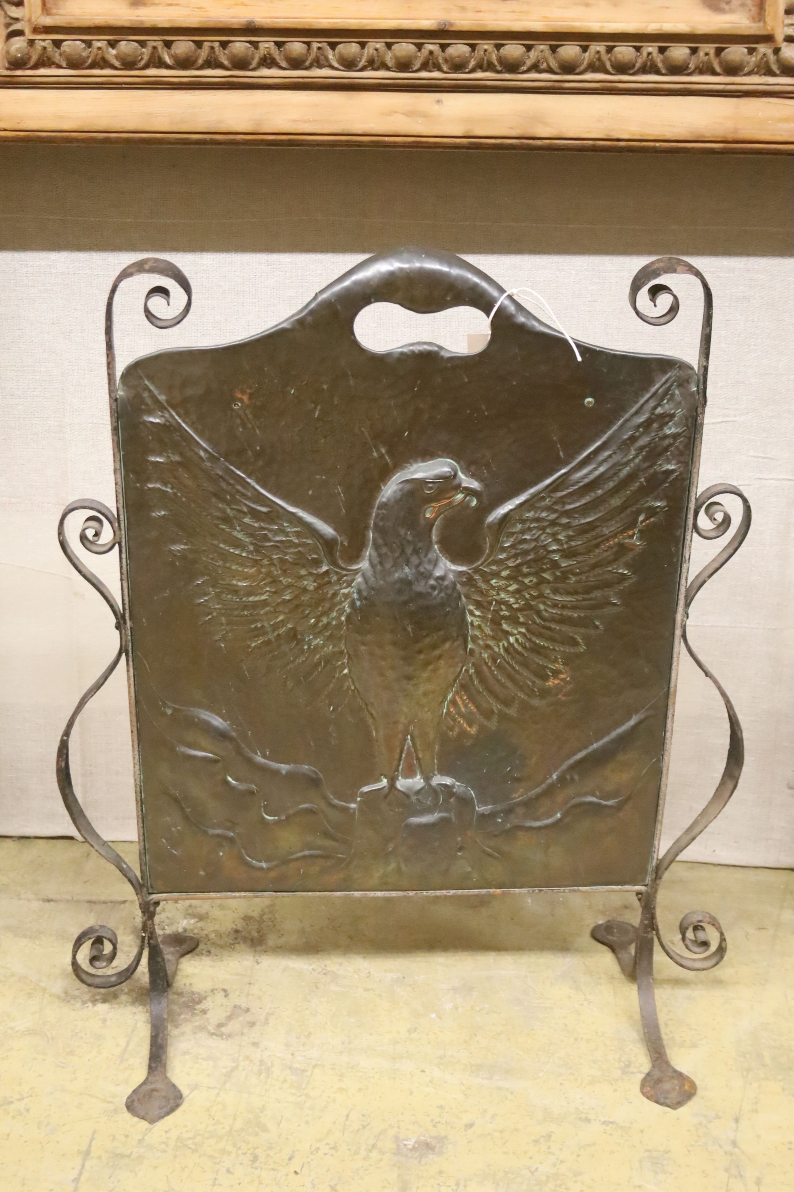 An Art Nouveau embossed copper firescreen, width 60cm, height 73cm